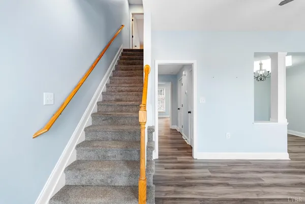 an empty room with closet and a chandelier fan