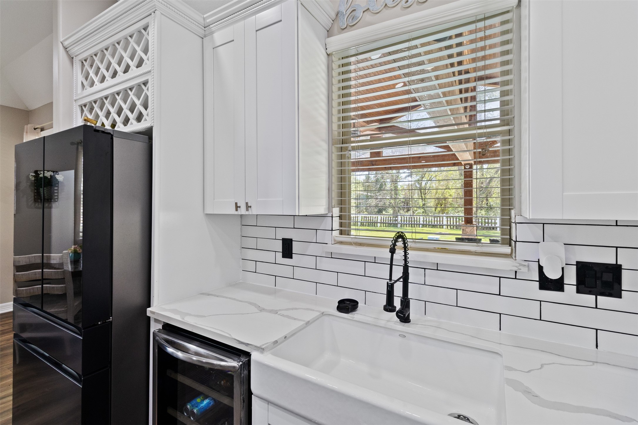 7927 Needlepoint Road Baytown, TX 77521 - Photo 12 of 46 a kitchen with a sink and a refrigerator