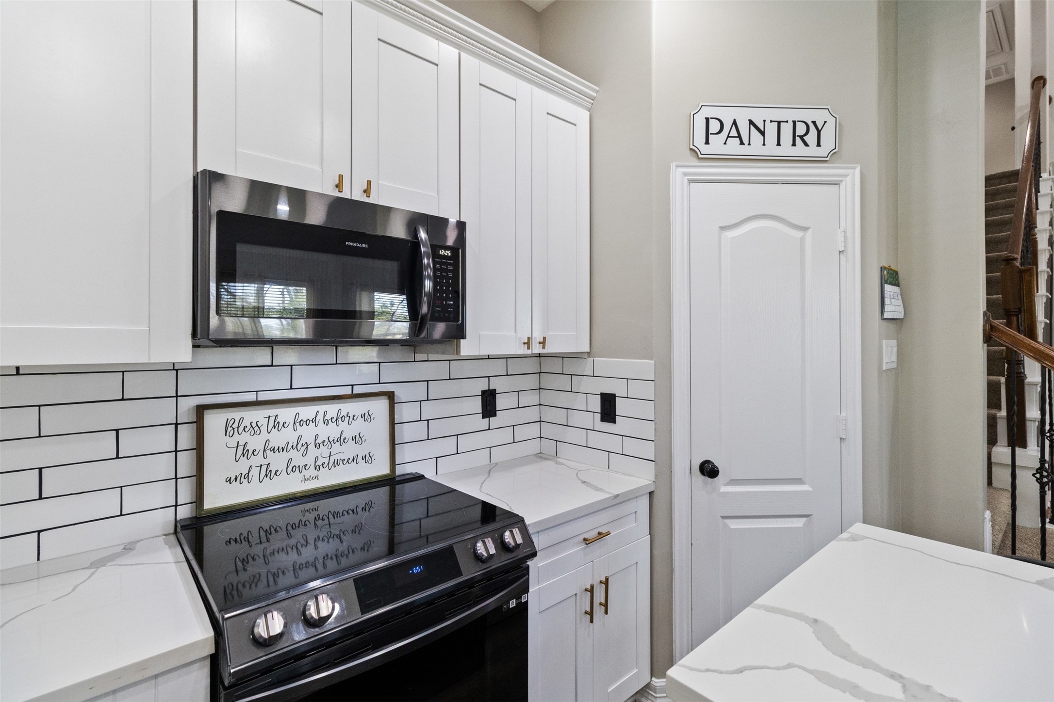 7927 Needlepoint Road Baytown, TX 77521 - Photo 14 of 46 a kitchen with a stove and a microwave