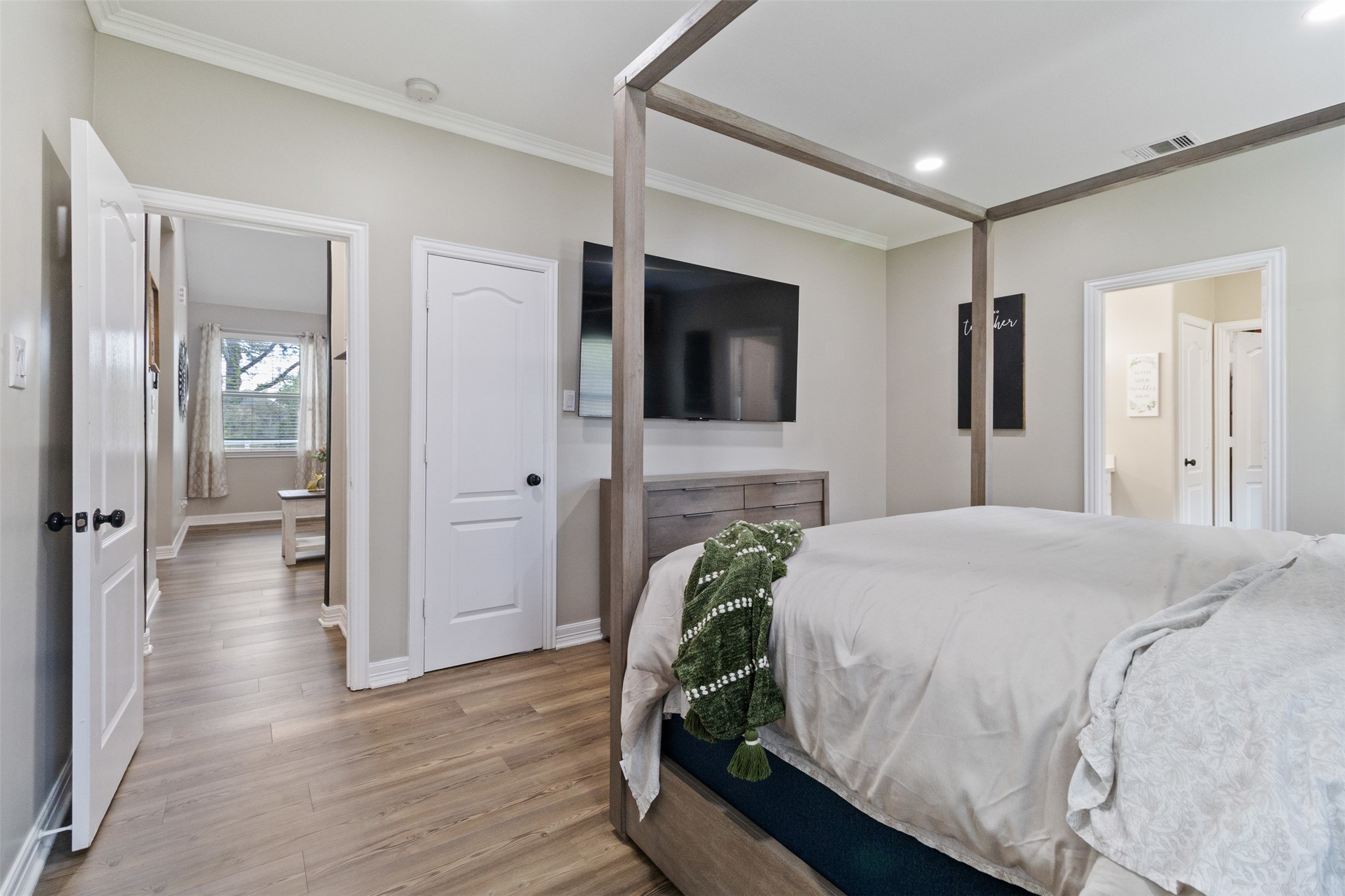 7927 Needlepoint Road Baytown, TX 77521 - Photo 16 of 46 a spacious bedroom with a bed and a flat screen tv