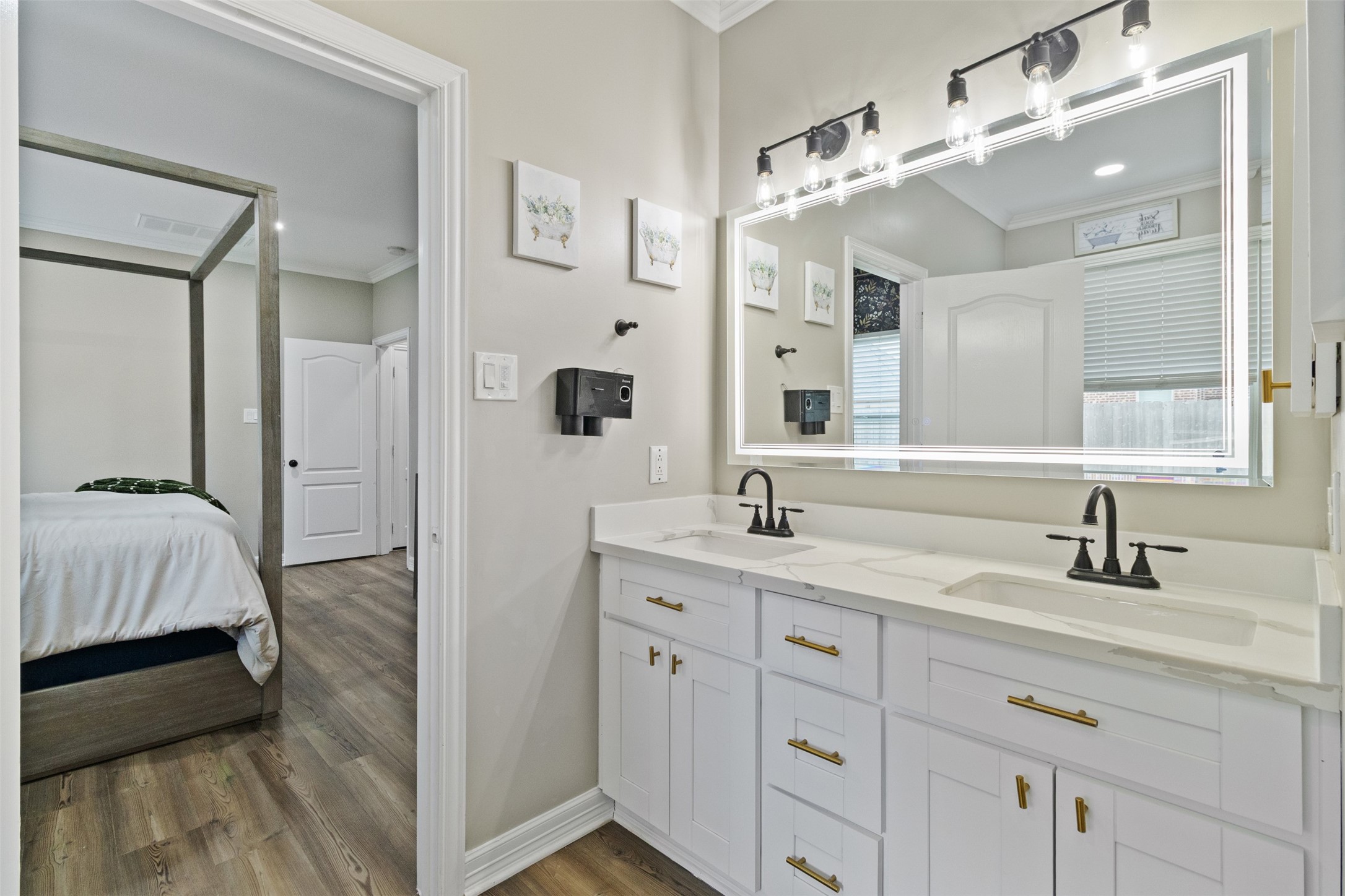 7927 Needlepoint Road Baytown, TX 77521 - Photo 20 of 46 a en suite bathroom with a double vanity sink and a mirror