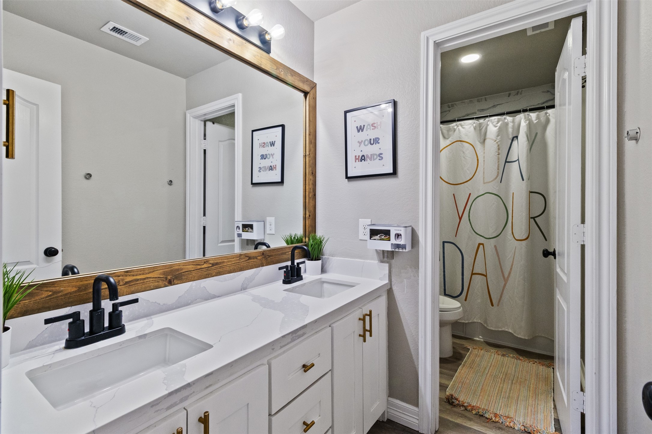 7927 Needlepoint Road Baytown, TX 77521 - Photo 30 of 46 a bathroom with a sink a mirror and shower