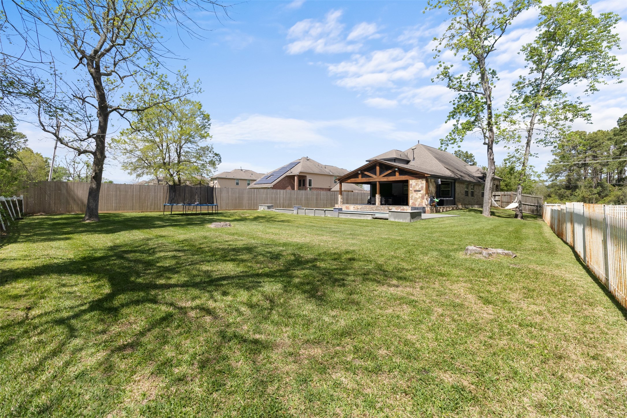 7927 Needlepoint Road Baytown, TX 77521 - Photo 39 of 46 a view of a house with a big yard and large trees