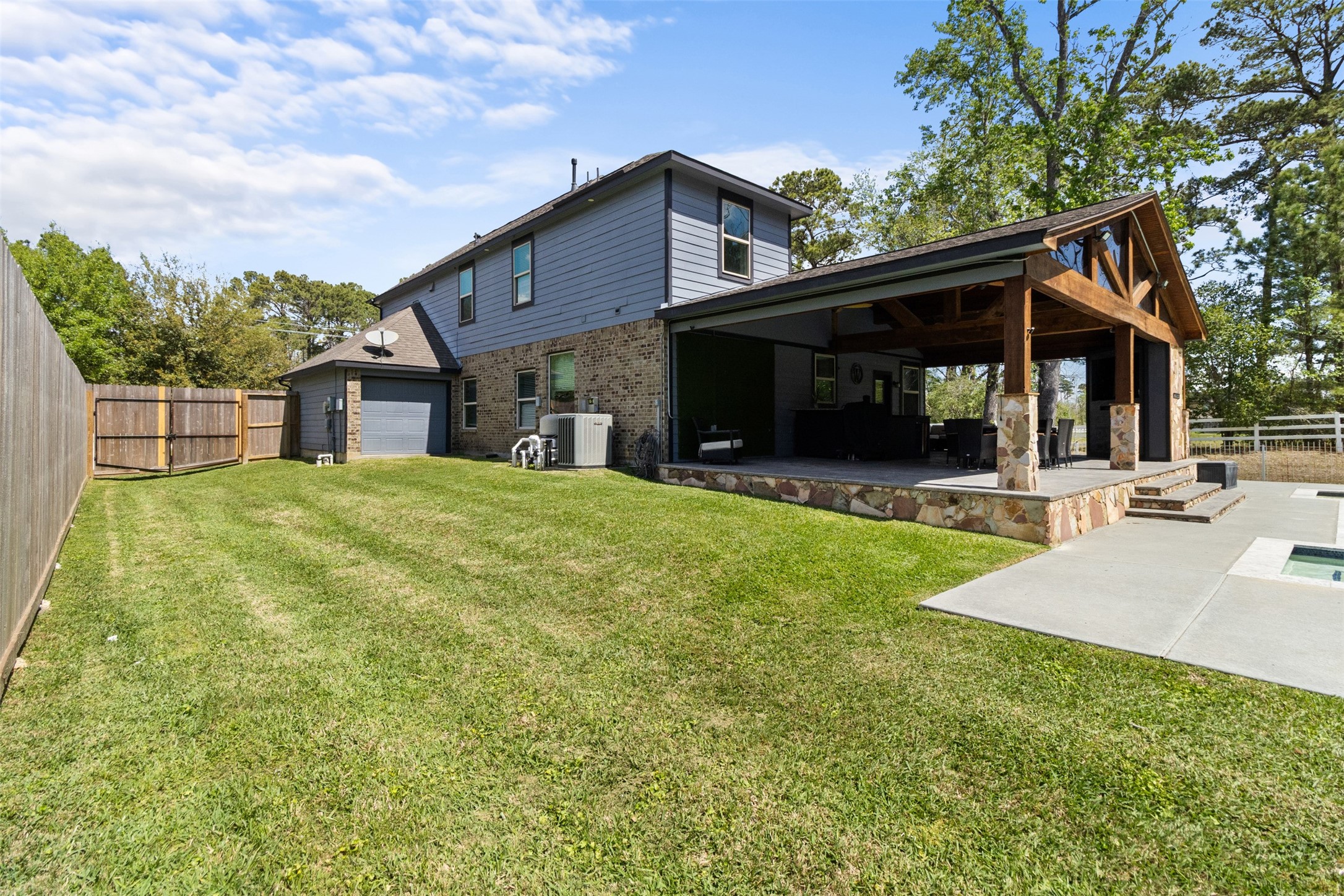 7927 Needlepoint Road Baytown, TX 77521 - Photo 41 of 46 a view of a house with a yard patio and fire pit