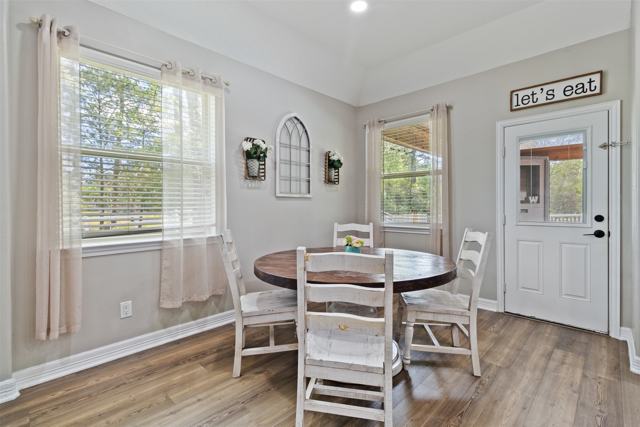 7927 Needlepoint Road Baytown, TX 77521 - Photo 10 of 46 a view of a dining room with furniture window and wooden floor