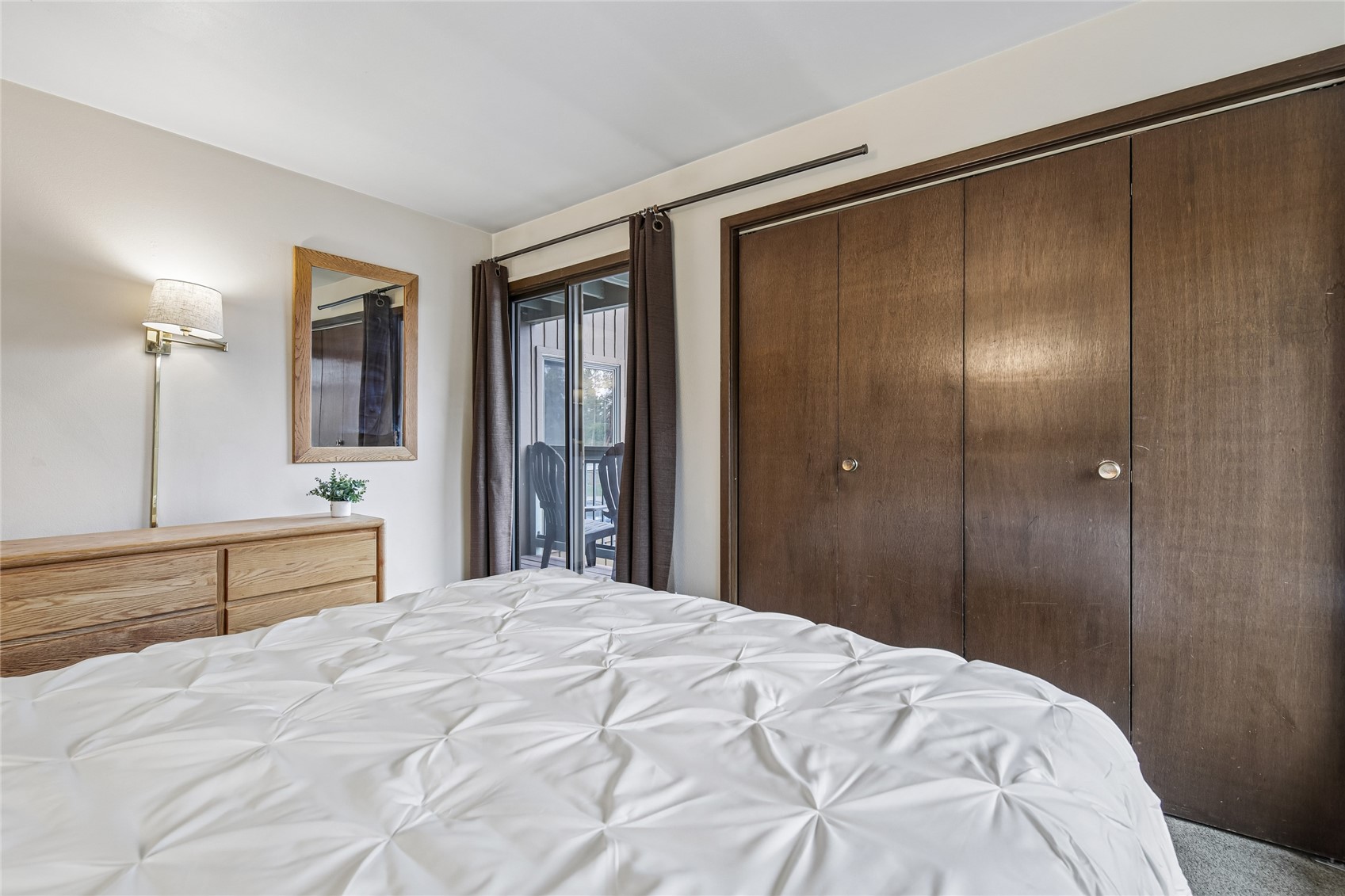 423 Wild Irishman Road, Unit 1008 1009 Keystone, CO 80435 - Photo 13 of 28 a bedroom with a large bed and a chandelier