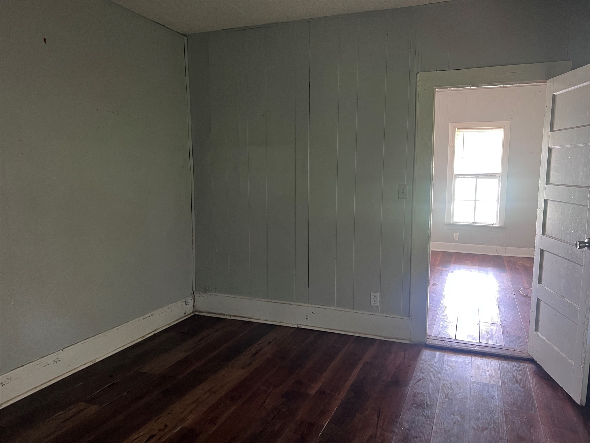 613 Harrison Lane Wharton, TX 77488 - Photo 10 of 10 an empty room with wooden floor and windows