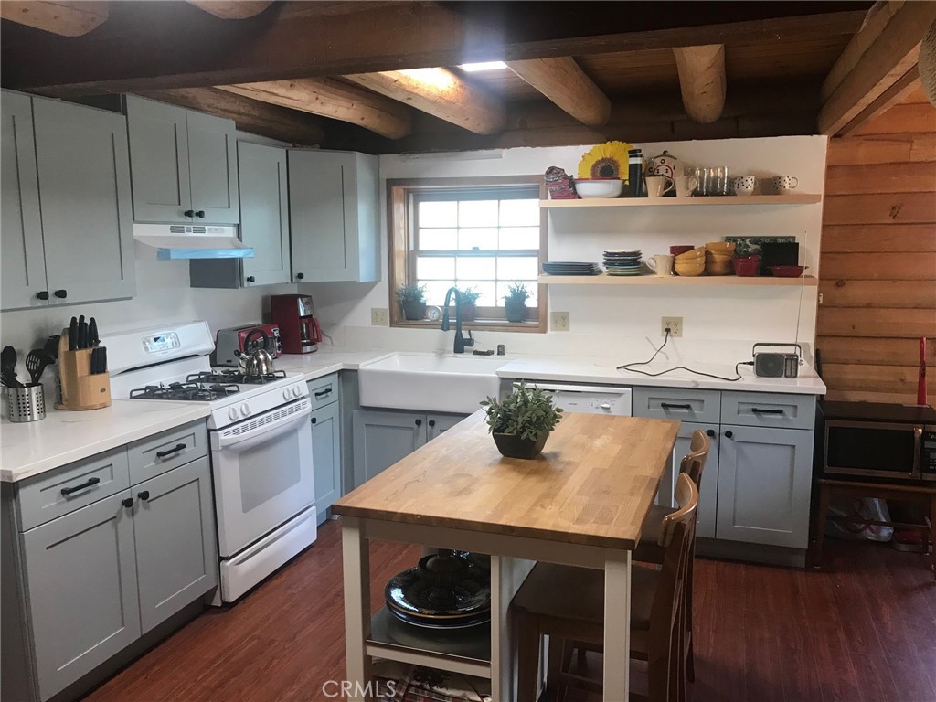 a kitchen with a sink a stove and cabinets
