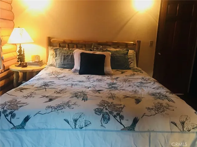 a dining room with wooden floor and white walls
