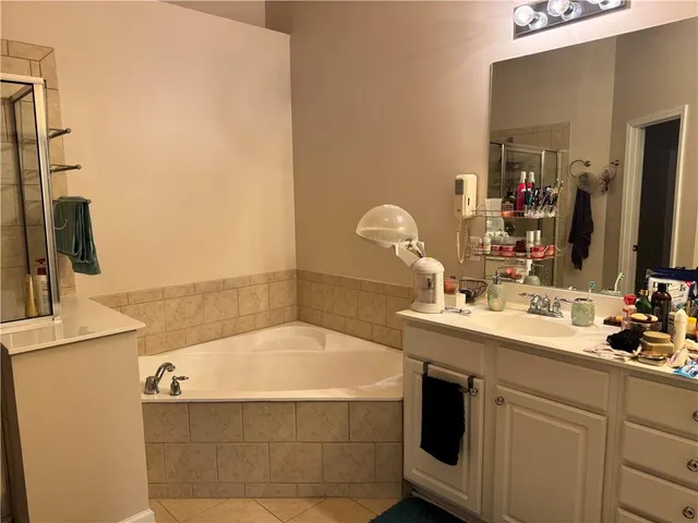 a bathroom with a bathtub and a shower