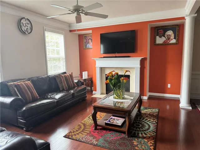 a living room with furniture a flat screen tv and a fireplace