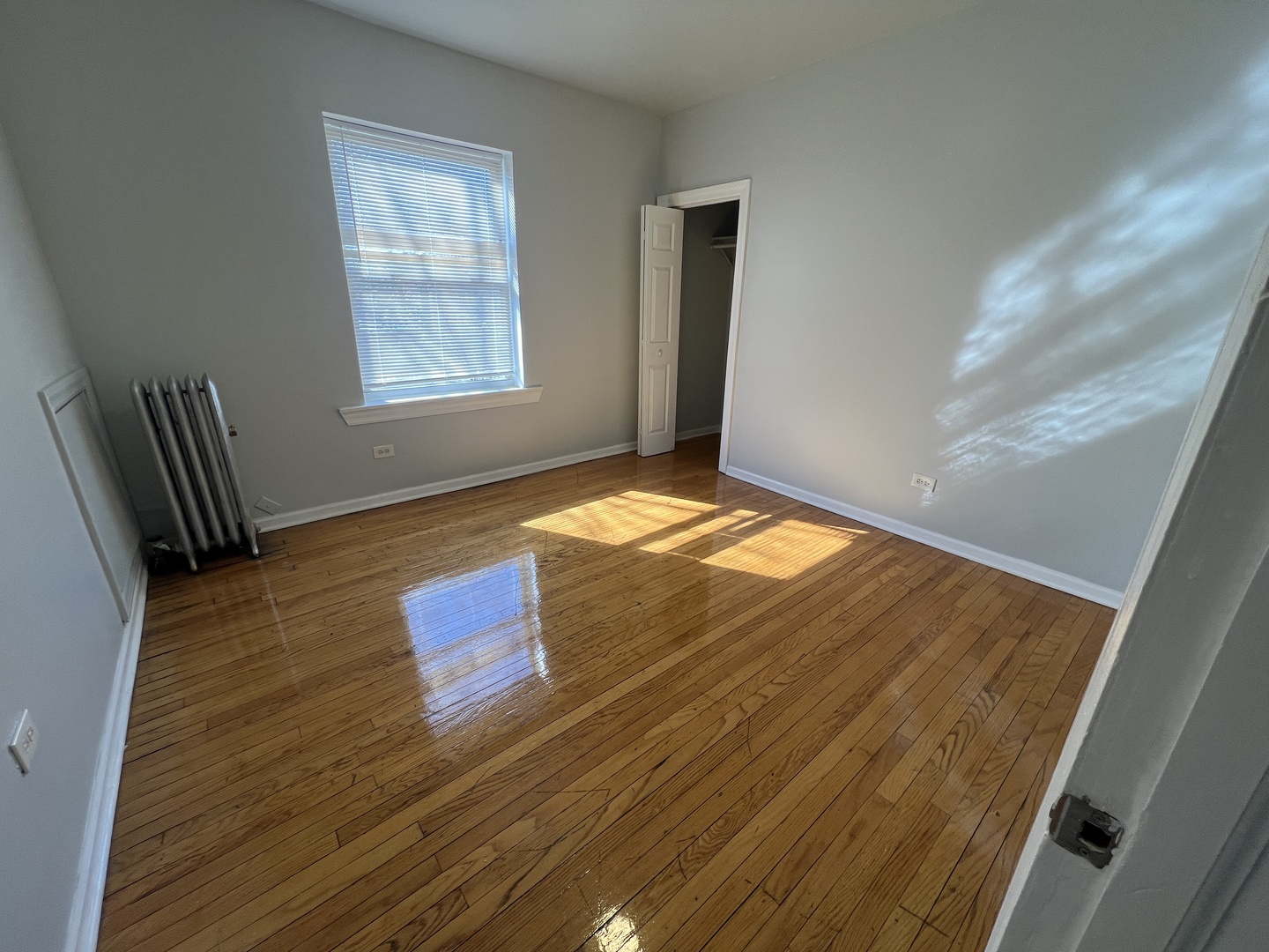 2047 East 68th Street, Unit 3W Chicago, IL 60649 - Photo 3 of 6 a view of empty room with wooden floor