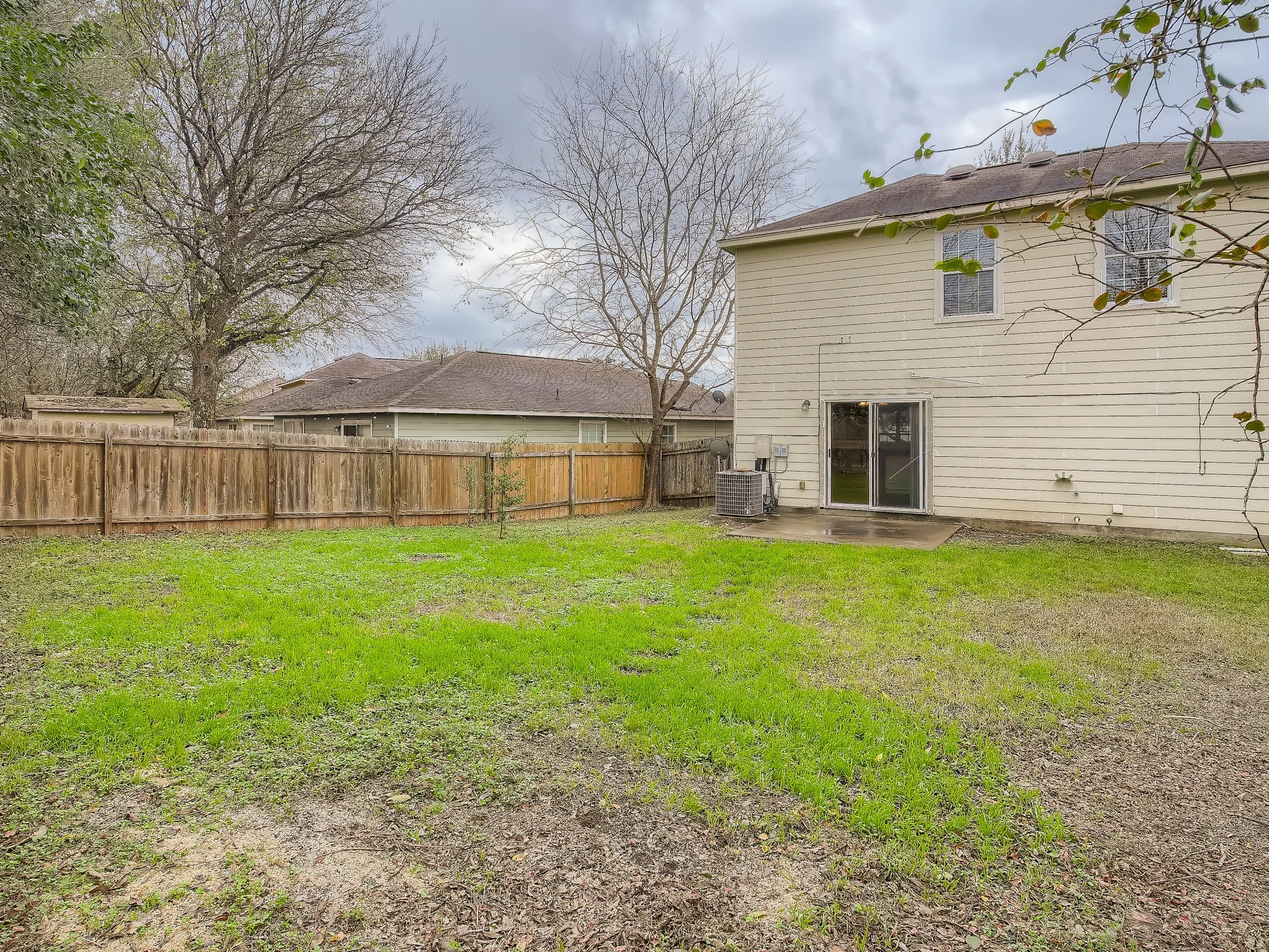 2002 Nogales Trail Austin, TX 78744 - Photo 15 of 16 a view of a house with backyard and a tree