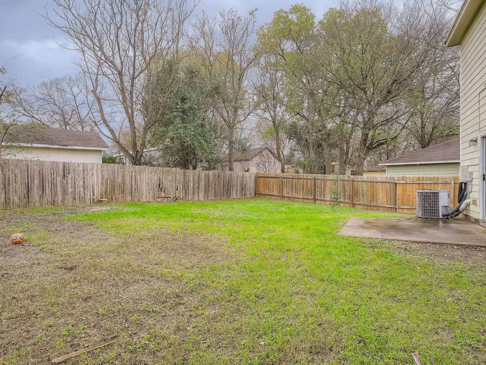 2002 Nogales Trail Austin, TX 78744 - Photo 16 of 16 a view of a yard with a large trees and wooden fence