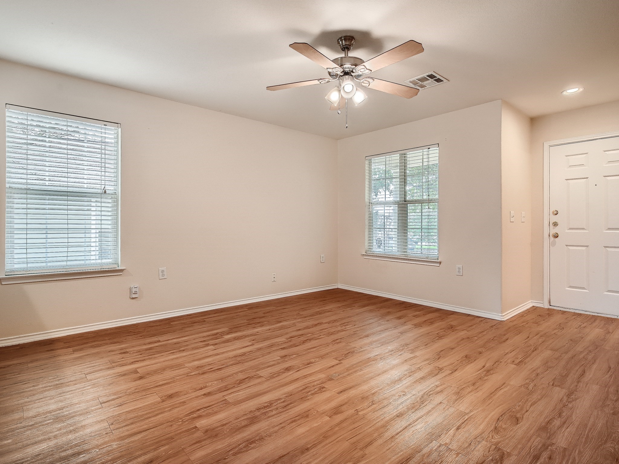 2002 Nogales Trail Austin, TX 78744 - Photo 3 of 16 an empty room with wooden floor and windows