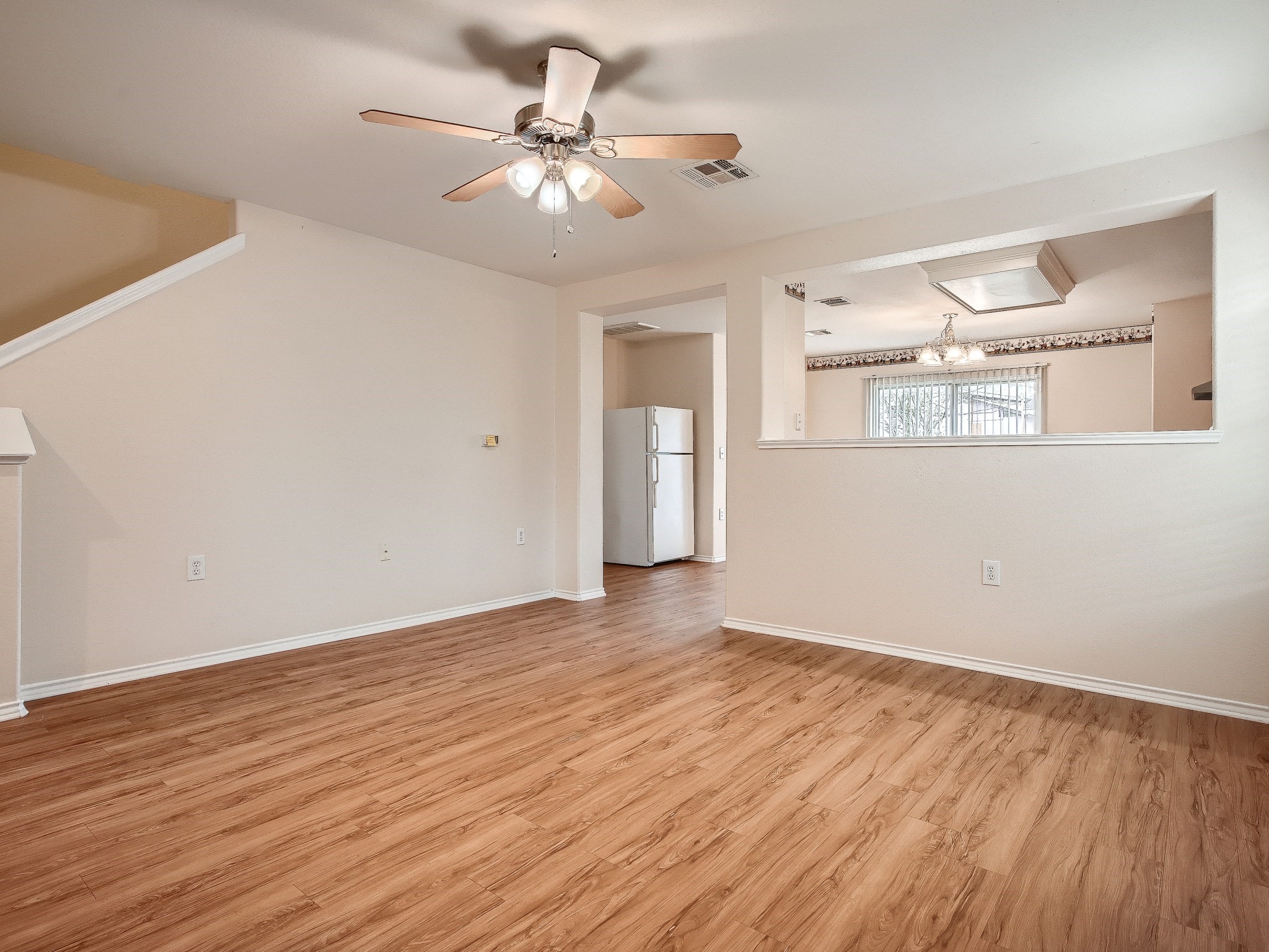 2002 Nogales Trail Austin, TX 78744 - Photo 4 of 16 a view of an empty room with wooden floor