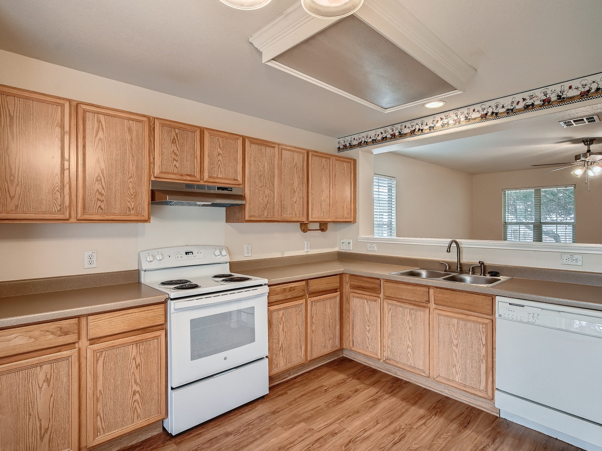 2002 Nogales Trail Austin, TX 78744 - Photo 5 of 16 a kitchen with a sink stove cabinets and wooden floor