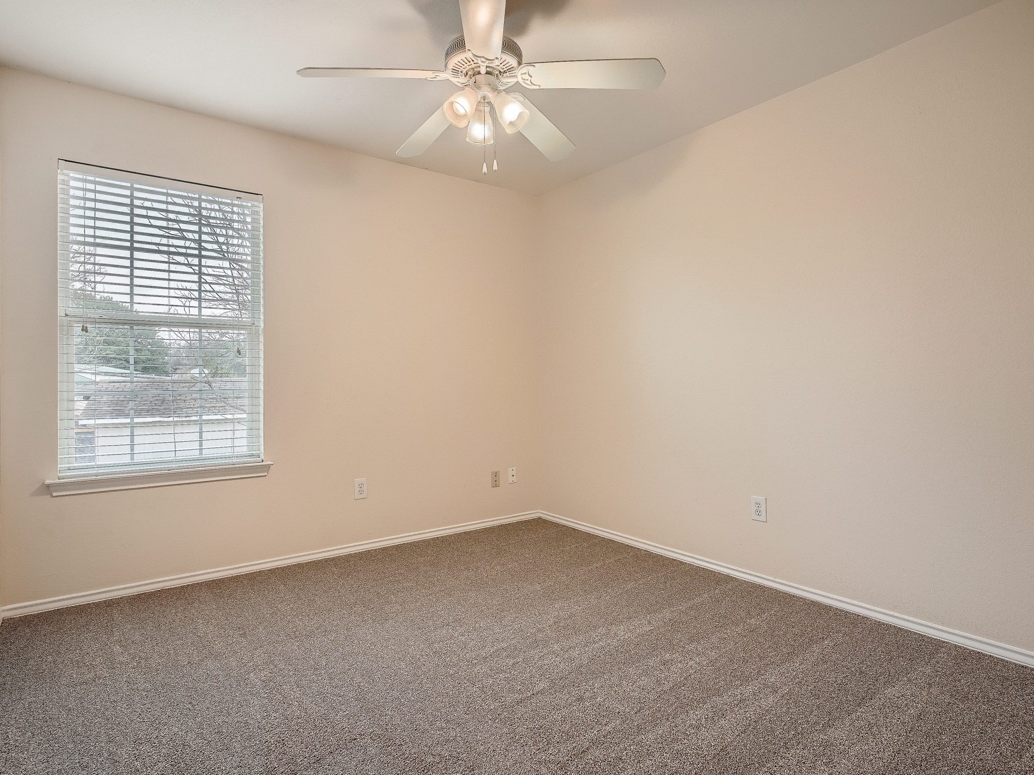 2002 Nogales Trail Austin, TX 78744 - Photo 10 of 16 an empty room with a window and a fan
