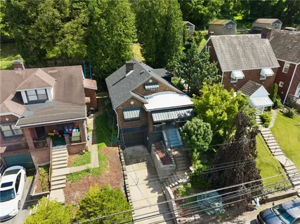 an aerial view of a house with a garden