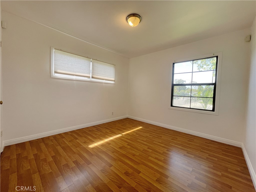 15100 Dunton Drive Whittier, CA 90604 - Photo 12 of 17 a view of empty room with wooden floor and fan