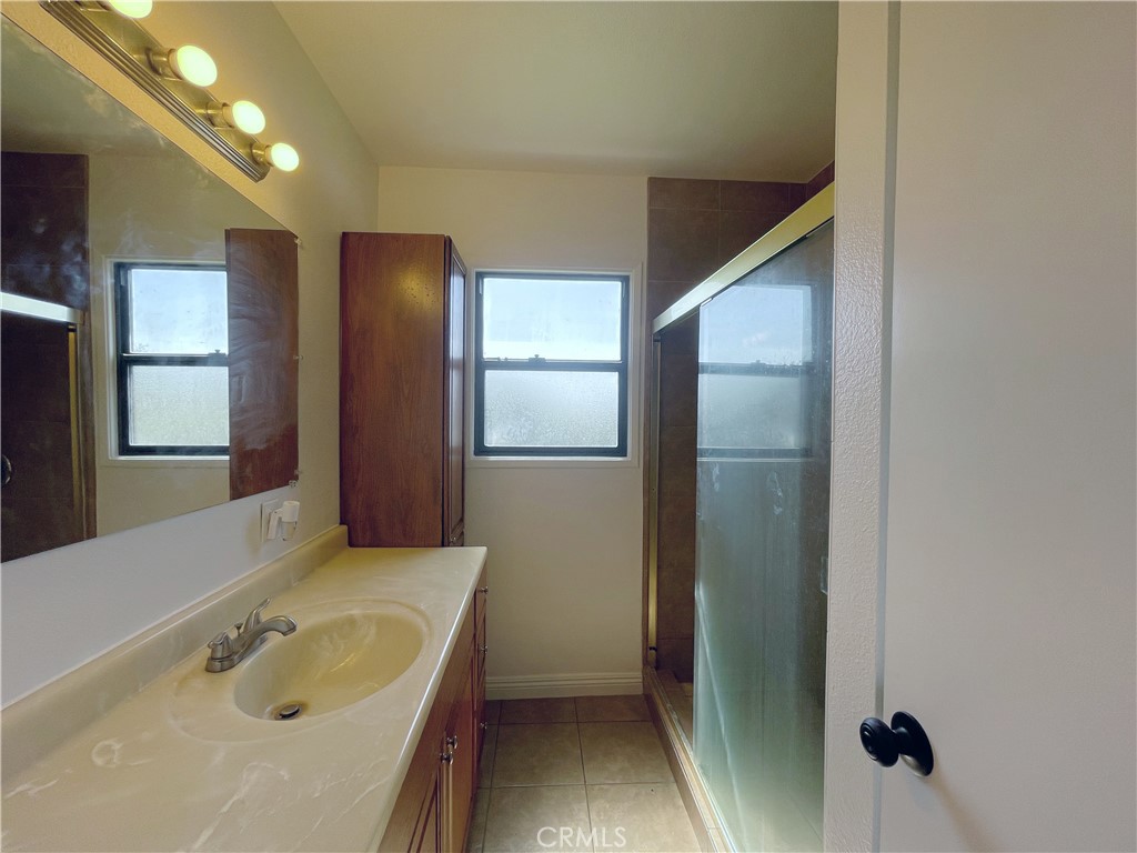 15100 Dunton Drive Whittier, CA 90604 - Photo 13 of 17 a bathroom with a tub sink and mirror