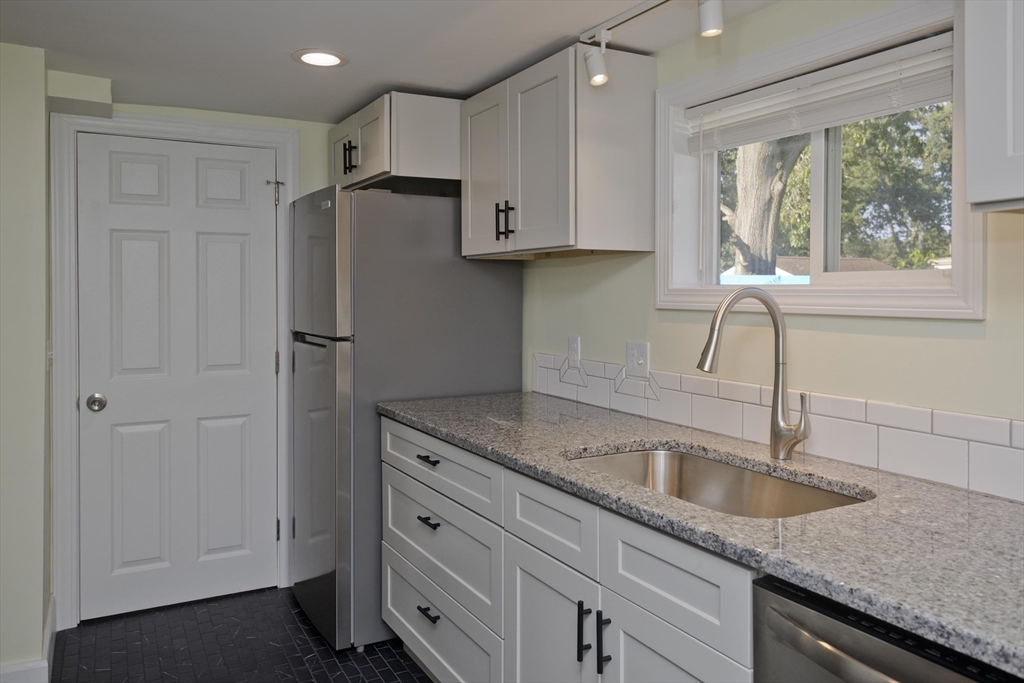 265 Ambrose Street Springfield, MA 01109 - Photo 5 of 24 a kitchen with stainless steel appliances granite countertop a sink a refrigerator and a granite counter tops