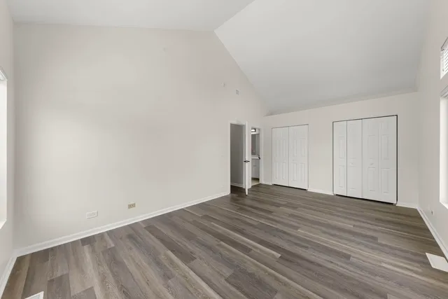 a view of an empty room and wooden floor