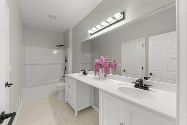 a bathroom with a sink a vanity and a mirror