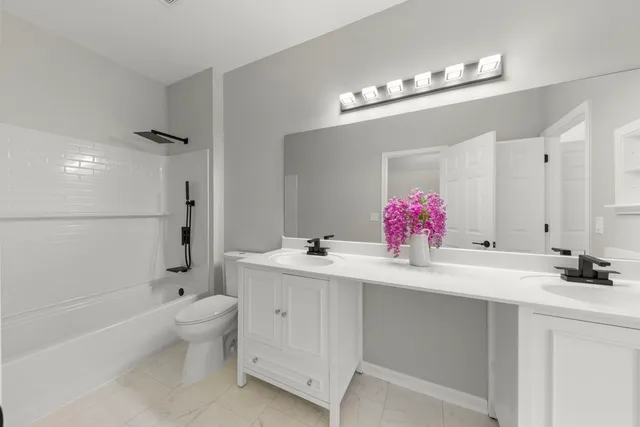 a bathroom with a bathtub shower sink and mirror