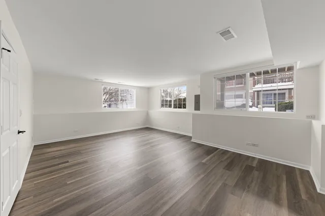 a view of a room with wooden floor and windows