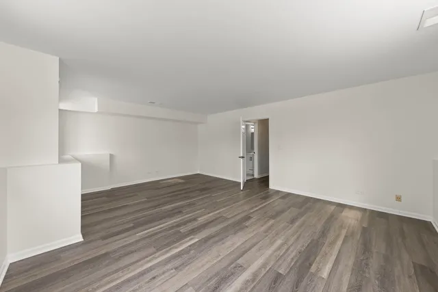 a view of an empty room and wooden floor