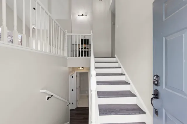 a view of entryway and hall with wooden floor