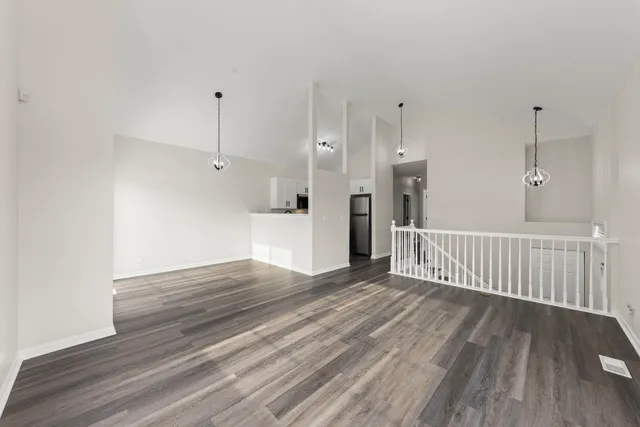 a view of a room with wooden floor and windows