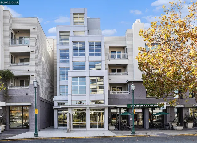 a front view of a building with glass windows and a table
