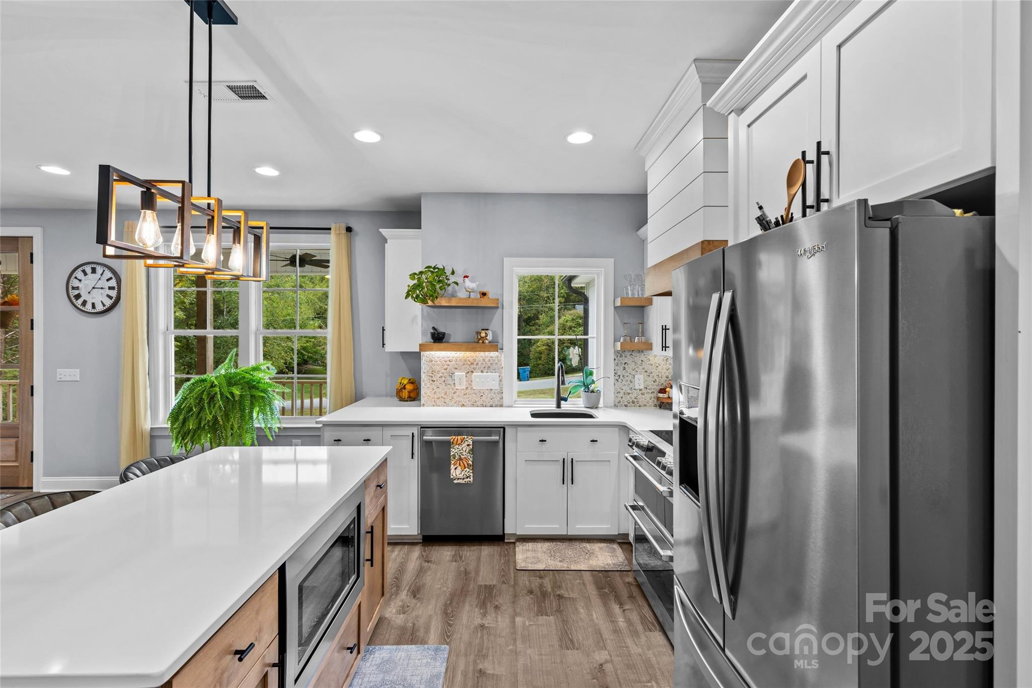 4815 Chadwick Drive Concord, NC 28025 - Photo 11 of 42 a kitchen with stainless steel appliances a refrigerator sink and wooden floor