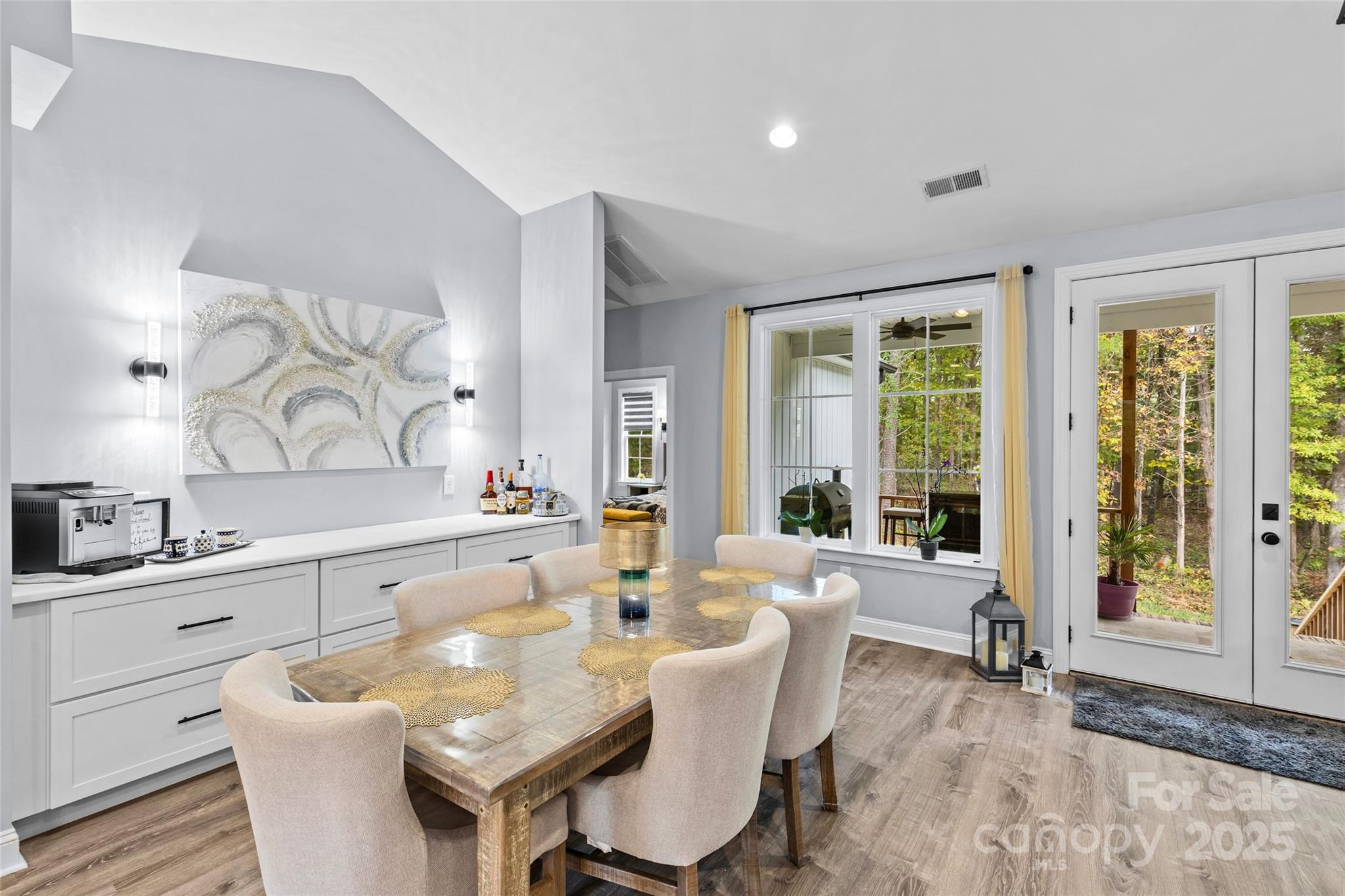 4815 Chadwick Drive Concord, NC 28025 - Photo 14 of 42 a view of a dining room with furniture a chandelier and wooden floor