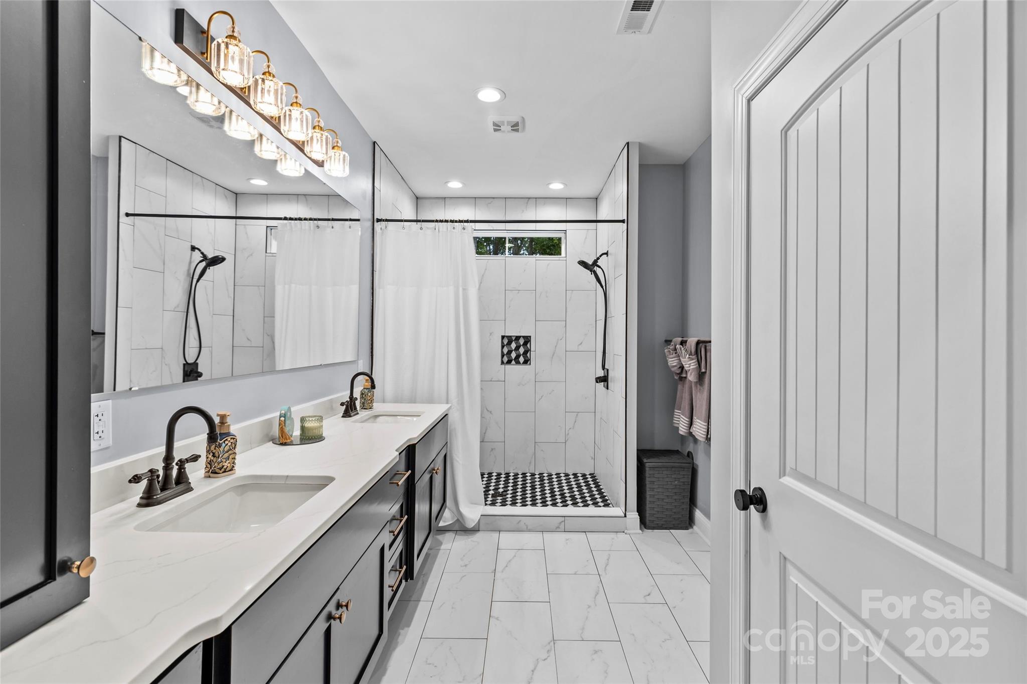 4815 Chadwick Drive Concord, NC 28025 - Photo 22 of 42 a bathroom with double vanity sink and mirror