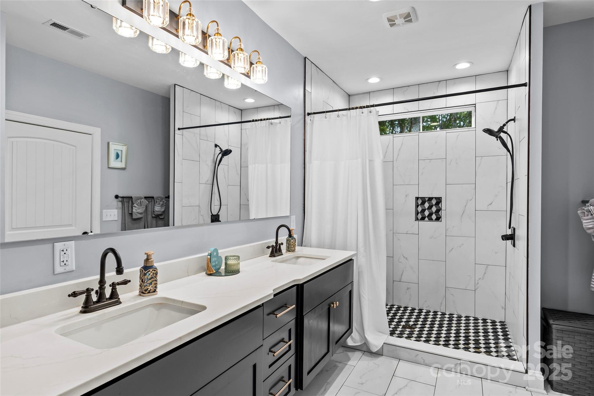 4815 Chadwick Drive Concord, NC 28025 - Photo 23 of 42 a bathroom with a sink double vanity and shower