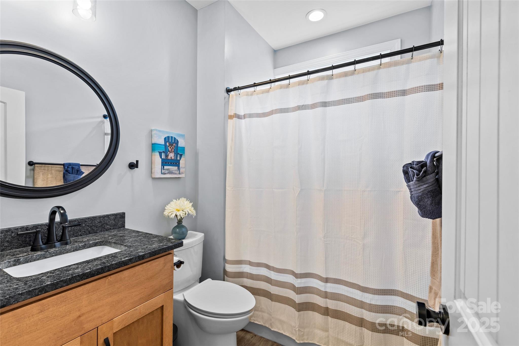 4815 Chadwick Drive Concord, NC 28025 - Photo 28 of 42 a bathroom with a granite countertop sink toilet and mirror
