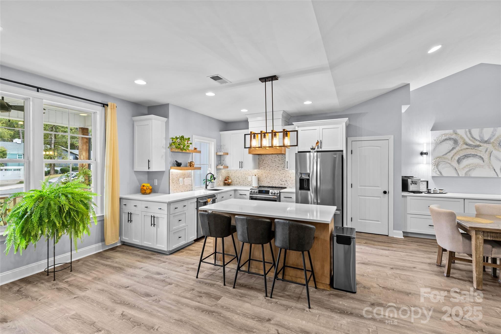 4815 Chadwick Drive Concord, NC 28025 - Photo 6 of 42 a kitchen with stainless steel appliances kitchen island granite countertop a table chairs sink and cabinets