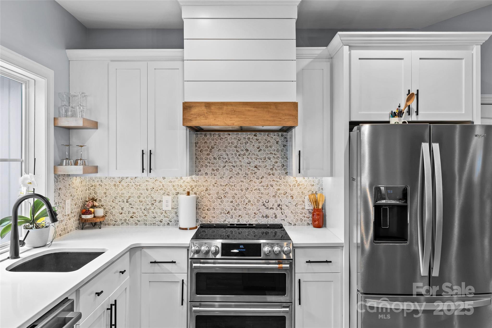 4815 Chadwick Drive Concord, NC 28025 - Photo 9 of 42 a kitchen with stainless steel appliances granite countertop a stove and a refrigerator