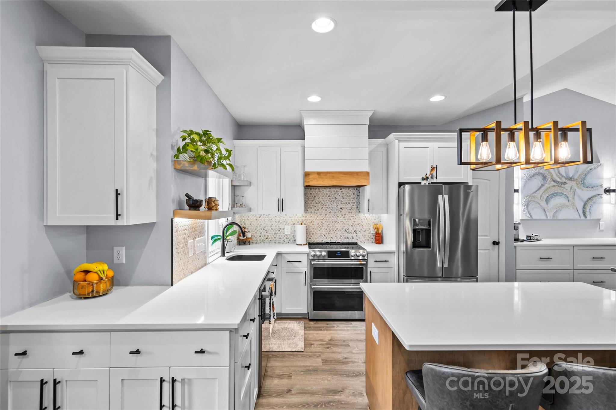 4815 Chadwick Drive Concord, NC 28025 - Photo 10 of 42 a kitchen with stainless steel appliances granite countertop a sink a stove and a refrigerator