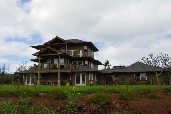 6867 Koolau Road Kilauea, HI 96754 - Photo 1 of 8 a front view of a house with a garden