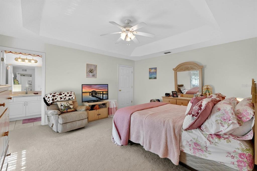 80 Roxboro Drive Palm Coast, FL 32164 - Photo 4 of 39 a bed room with a bed furniture and a chandelier