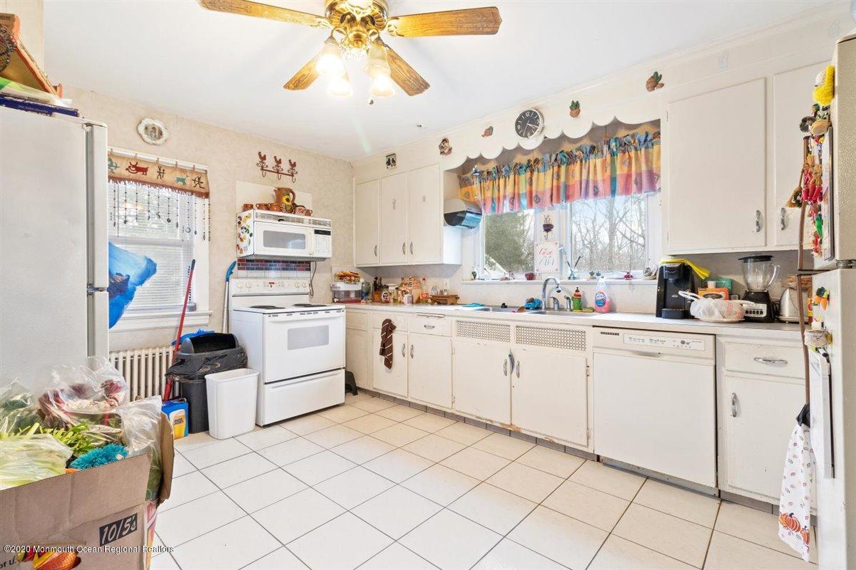 321 Pfister Road Jackson, NJ 08527 - Photo 14 of 30 a kitchen with a white cabinets and window