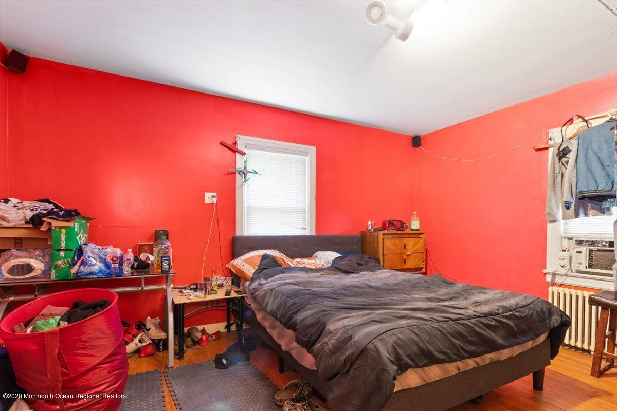 321 Pfister Road Jackson, NJ 08527 - Photo 19 of 30 a bed sitting in a bedroom next to a lamp