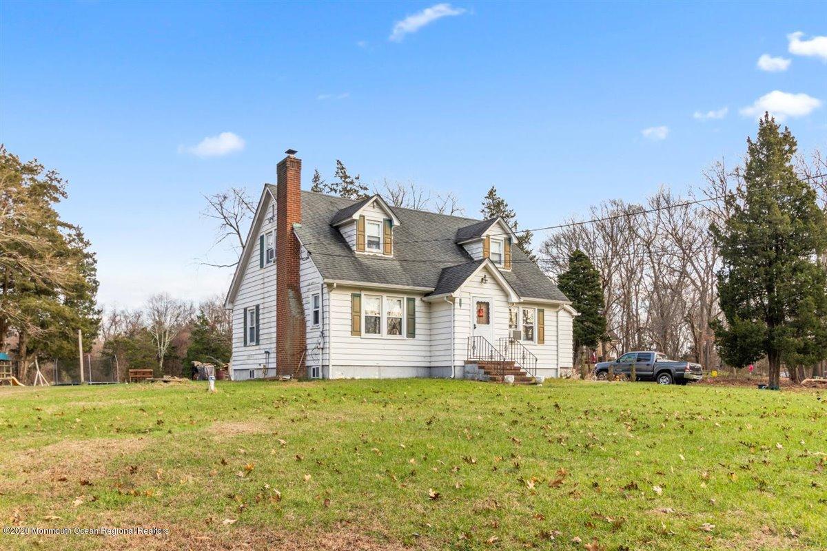 321 Pfister Road Jackson, NJ 08527 - Photo 5 of 30 a view of a white house with a big yard and large trees