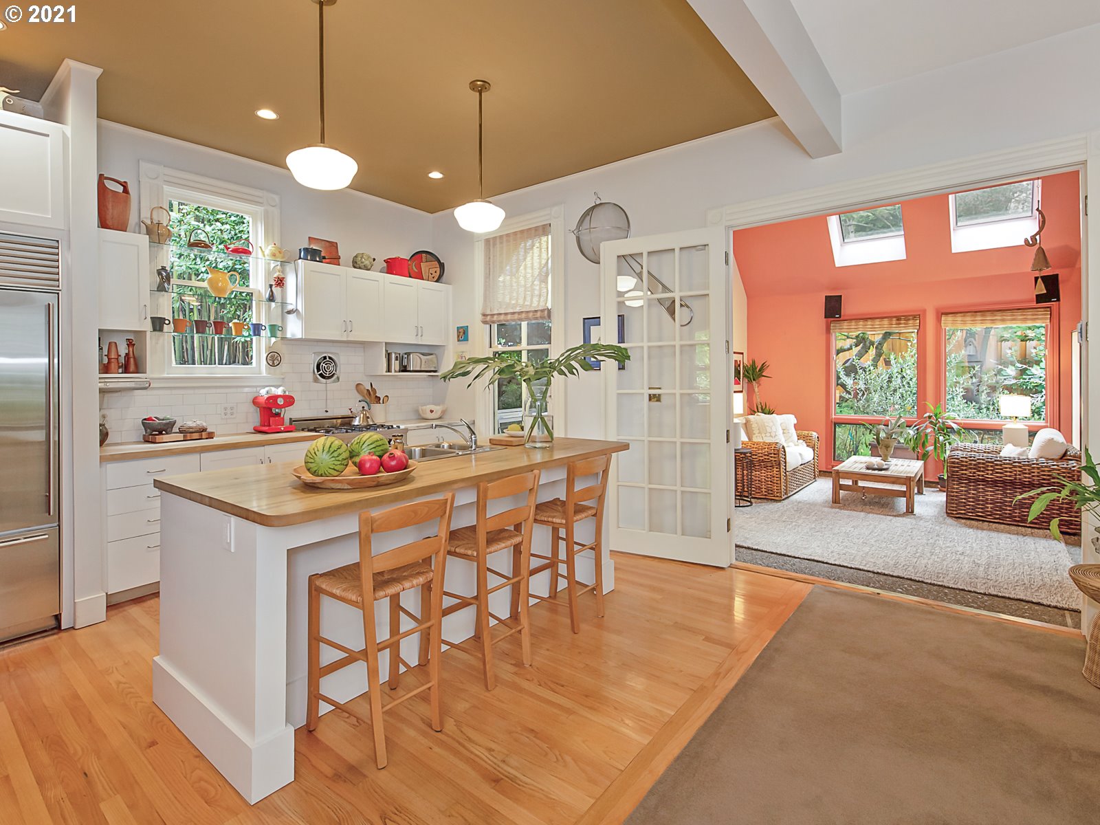 124 Southwest Meade Street Portland, OR 97201 - Photo 13 of 32 a kitchen with a dining table chairs sink and white cabinets