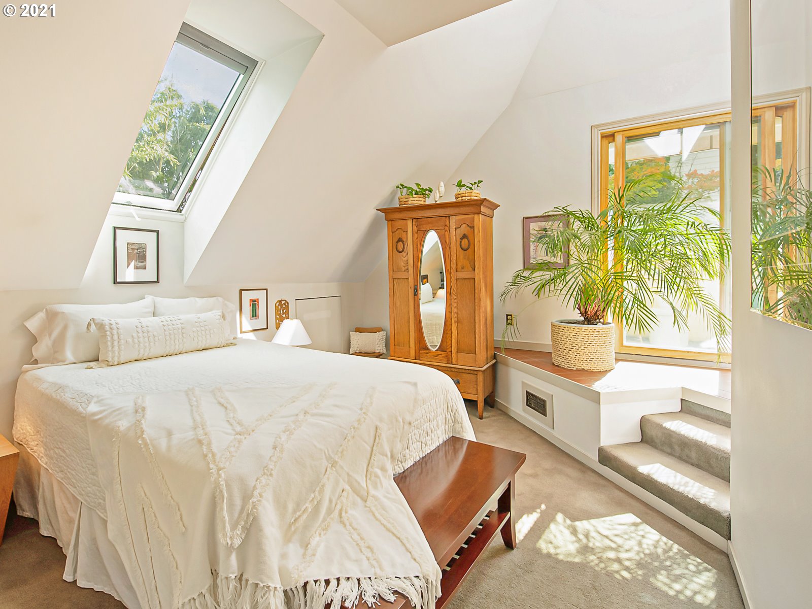 124 Southwest Meade Street Portland, OR 97201 - Photo 21 of 32 a spacious bedroom with a bed and a large window