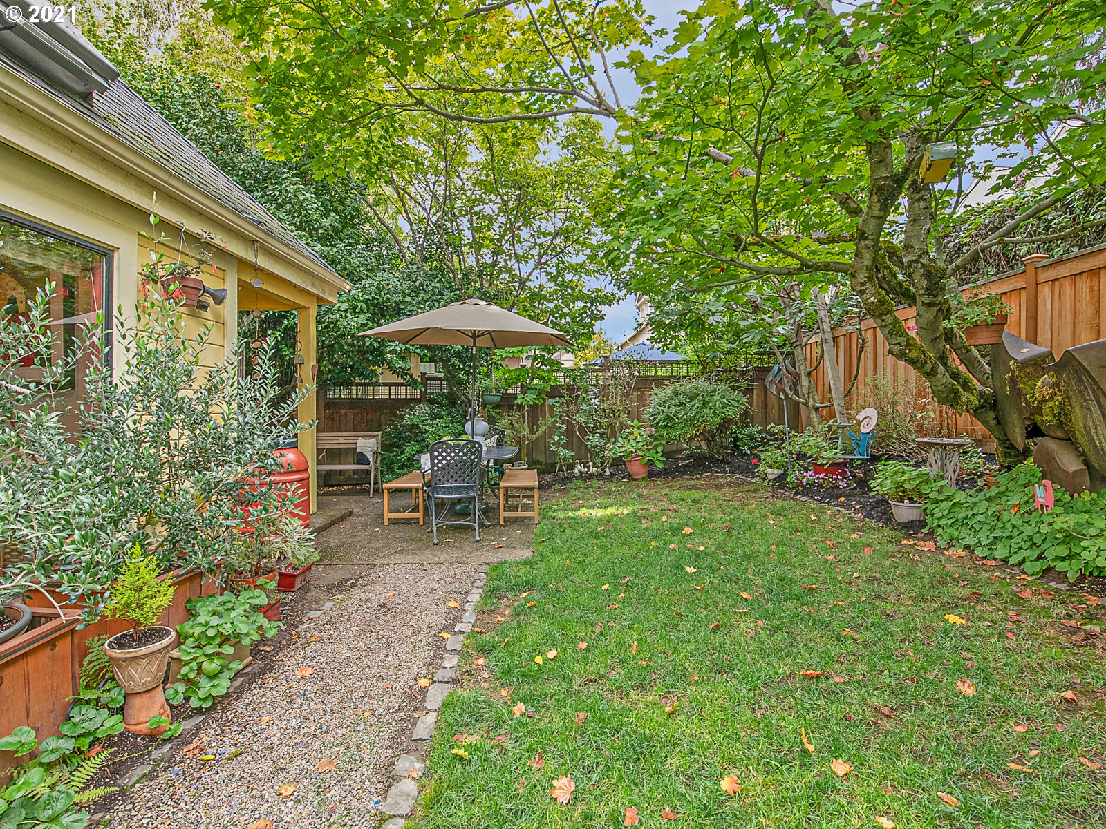 124 Southwest Meade Street Portland, OR 97201 - Photo 31 of 32 a view of backyard with table and chairs and potted plants